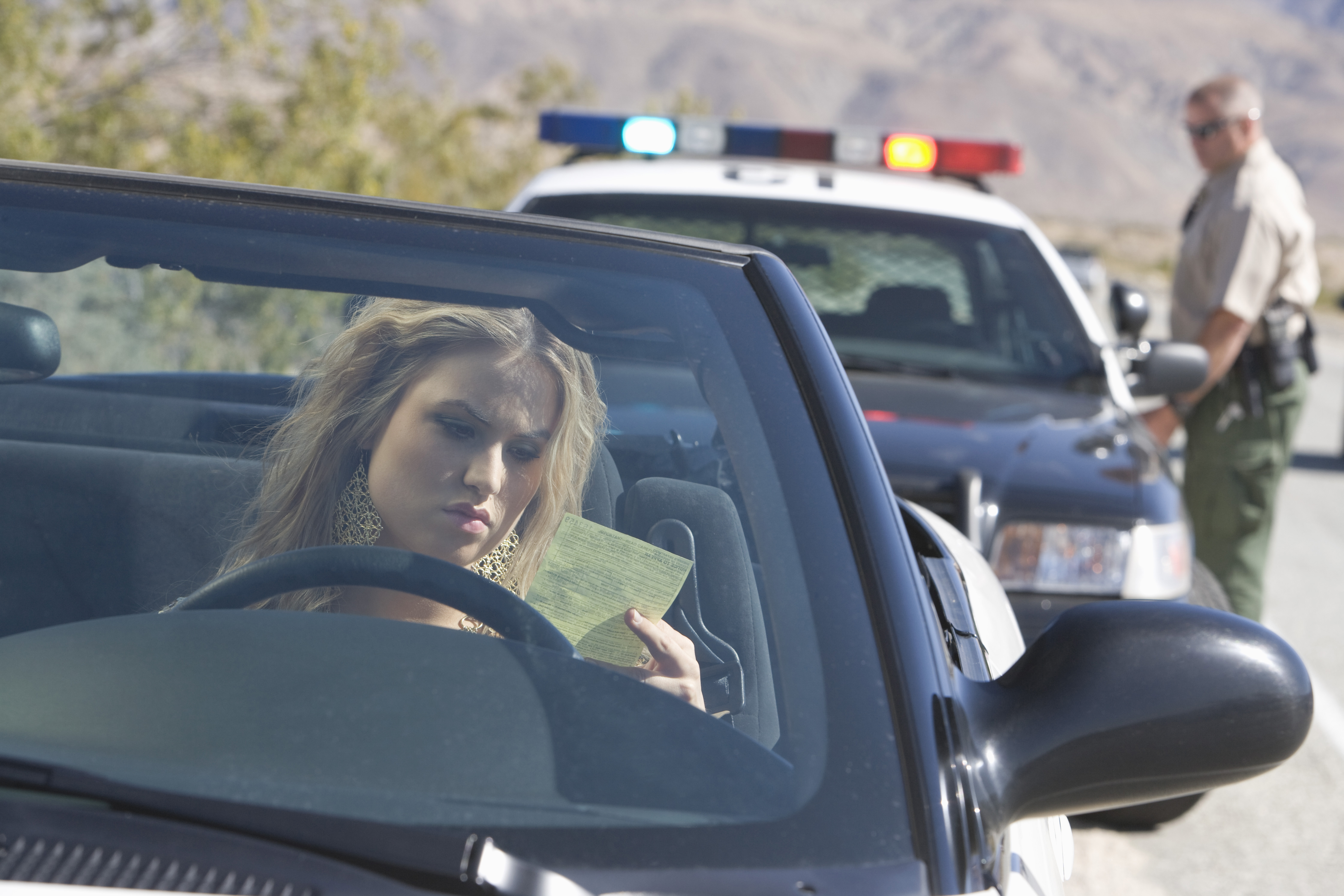 Young Woman Reading A Traffic Ticket